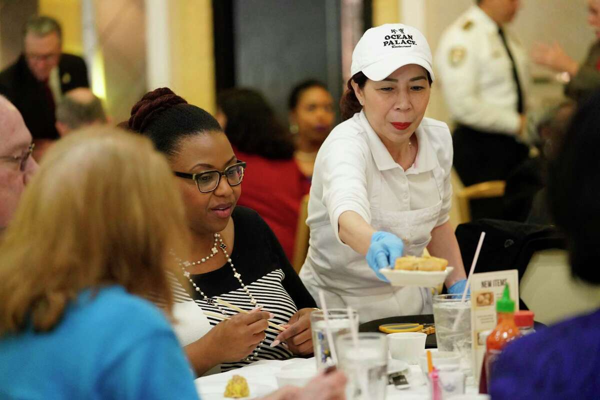Tieu Buu Luong serves lunch at Ocean Palace Restaurant, 11215 Bellaire Blvd., Thursday, March 5, 2020, in Houston. Mayor Sylvester Turner gathered with a couple dozen staff members and city officials for lunch at Ocean Palace in Asiatown in a bid to alleviate concerns and tamp down on rumors about COVID-19.