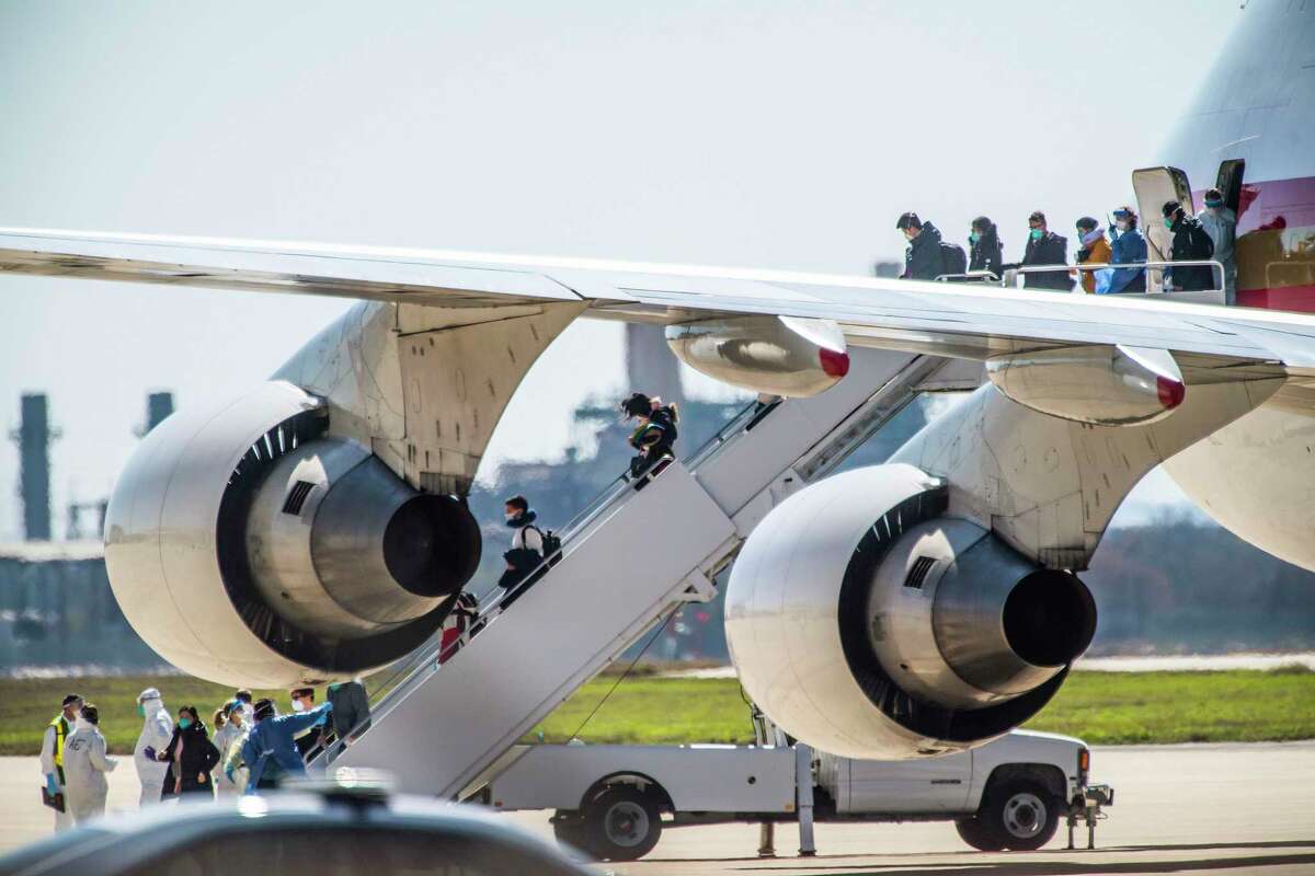 Evacuees at risk of carrying the coronavirus arrive at Joint Base San Antonio-Lackland aboard a chartered Boeing 747 on Feb. 7, 2020.