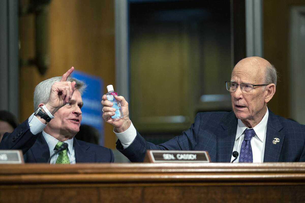 Senator Pat Roberts, a Republican from Kansas, right, holds up a bottle of hand sanitizer during a U.S. Senate Committee on Health, Education, Labor, and Pensions hearing at the U.S. Capitol in Washington, D.C., U.S., on Tuesday, March 3, 2020. Senators questioned Trump administration scientists Tuesday about the availability of coronavirus tests, treatment for those infected and a vaccine, as the number of infections and deaths in the U.S. continues to grow. Photographer: Stefani Reynolds/Bloomberg
