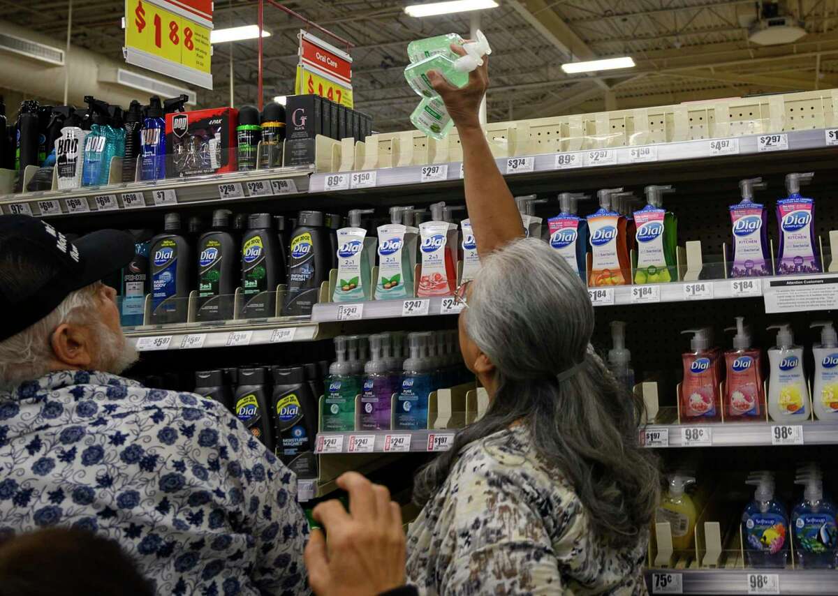 While the Trump administration has muddled its messages about the coronavirus, the run on hand sanitizer reflects public concern, a reader says. Here, shoppers reach for the last bottles of hand sanitizer bottles at the H-E-B in Olmos Park last week.