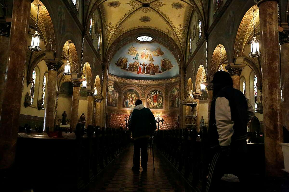Visitors to the Gubbio Project walk through St. Boniface Church on Thursday, March 5, 2020 in San Francisco, Calif.