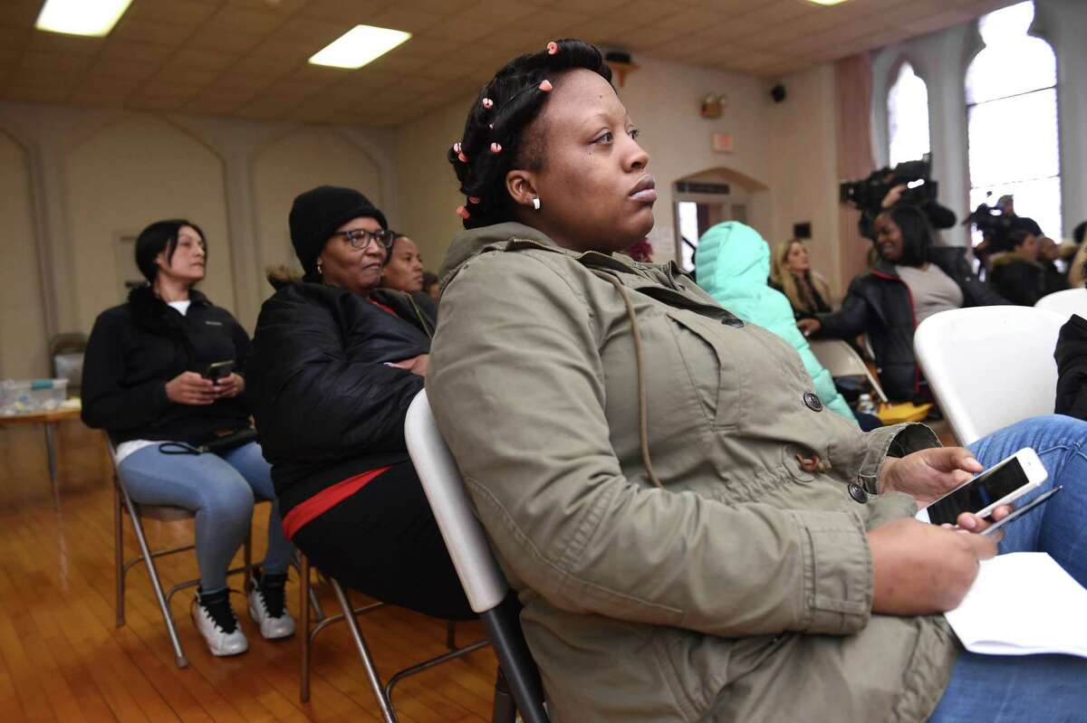Carolyn Kornegay (center) and Holly Henderson (right) were among former residents of Church Street South present for a presentation by Attorney David Rosen about a class action settlement for former residents of the housing complex at Trinity Lutheran Church in New Haven on March 6, 2020.