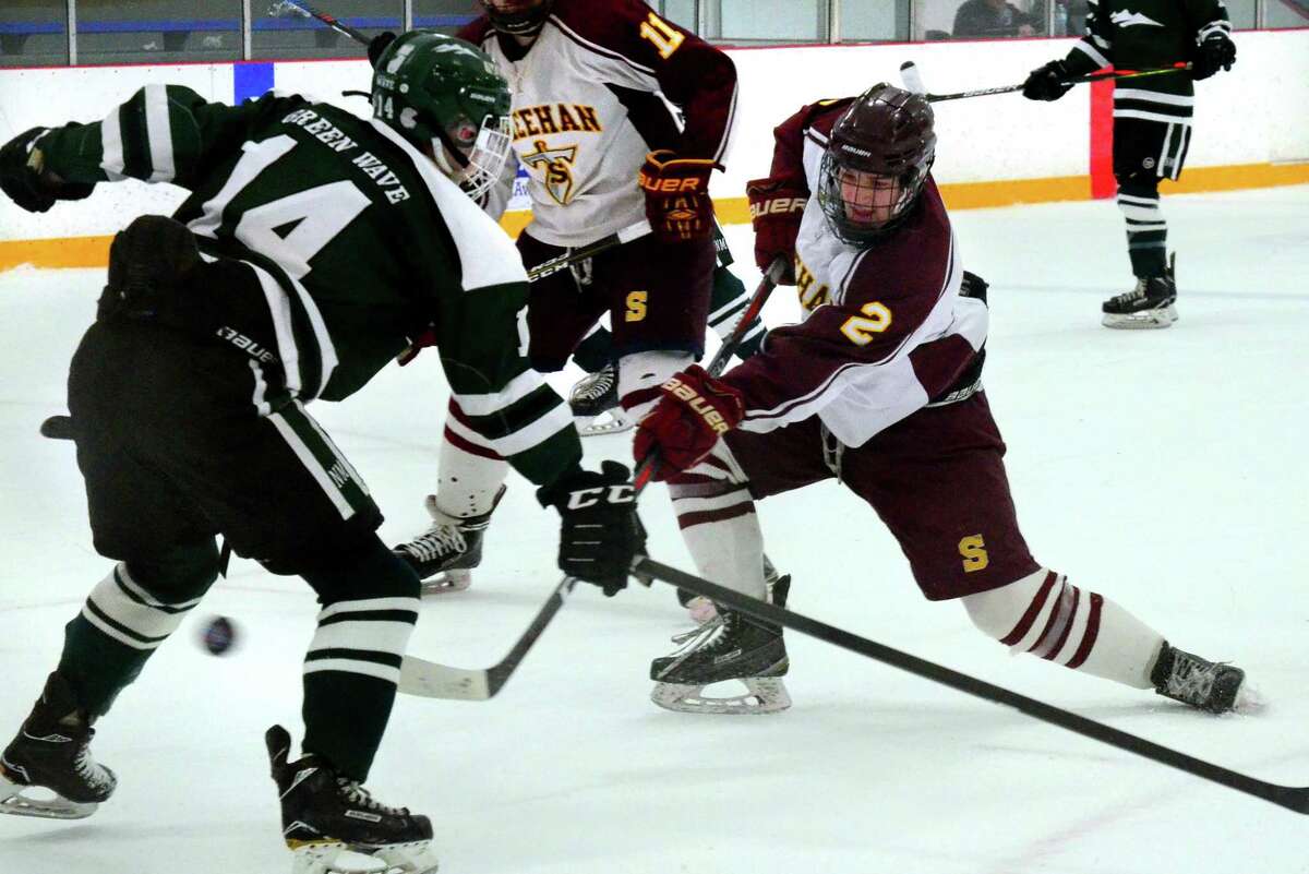 Sheehan's Anthony Romano (2) sends the puck to the New Milford goal to score during SCC Div. III Championship hockey action in West Haven, Conn., on Friday Mar. 6, 2020.