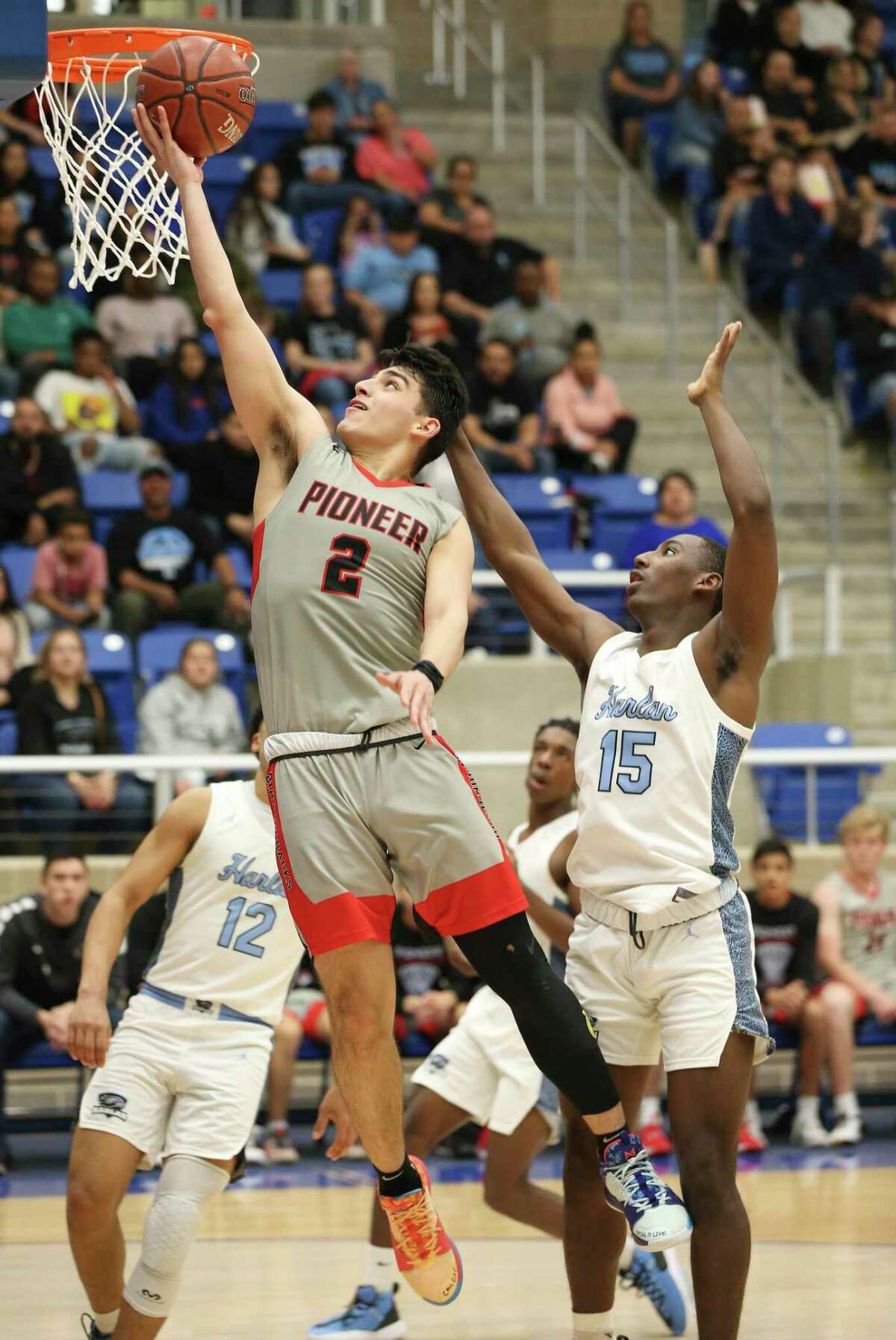 Sharyland Pioneer's Derek Luna (02) scores against Harlan's Ja'kobe Barkley (15) during their Boys 5A Regional semifinal basketball game on Friday, Mar. 6, 2020. Harlan defeated Pioneer, 71-65, to advance to the regional final.