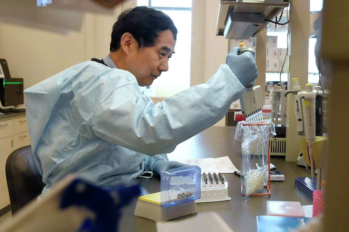 Microbiologist Xiugen Zhang runs a Polymerase Chain Reaction (PCR) test at the Connecticut State Public Health Laboratory, Monday, March 2, 2020, in Rocky Hill, Conn. The Connecticut Department of Public Health has received federal approval from the Centers for Disease Control and Prevention and the Food and Drug Administration to run diagnostic testing for the coronavirus at the department's lab in Rocky Hill. (AP Photo/Jessica Hill)