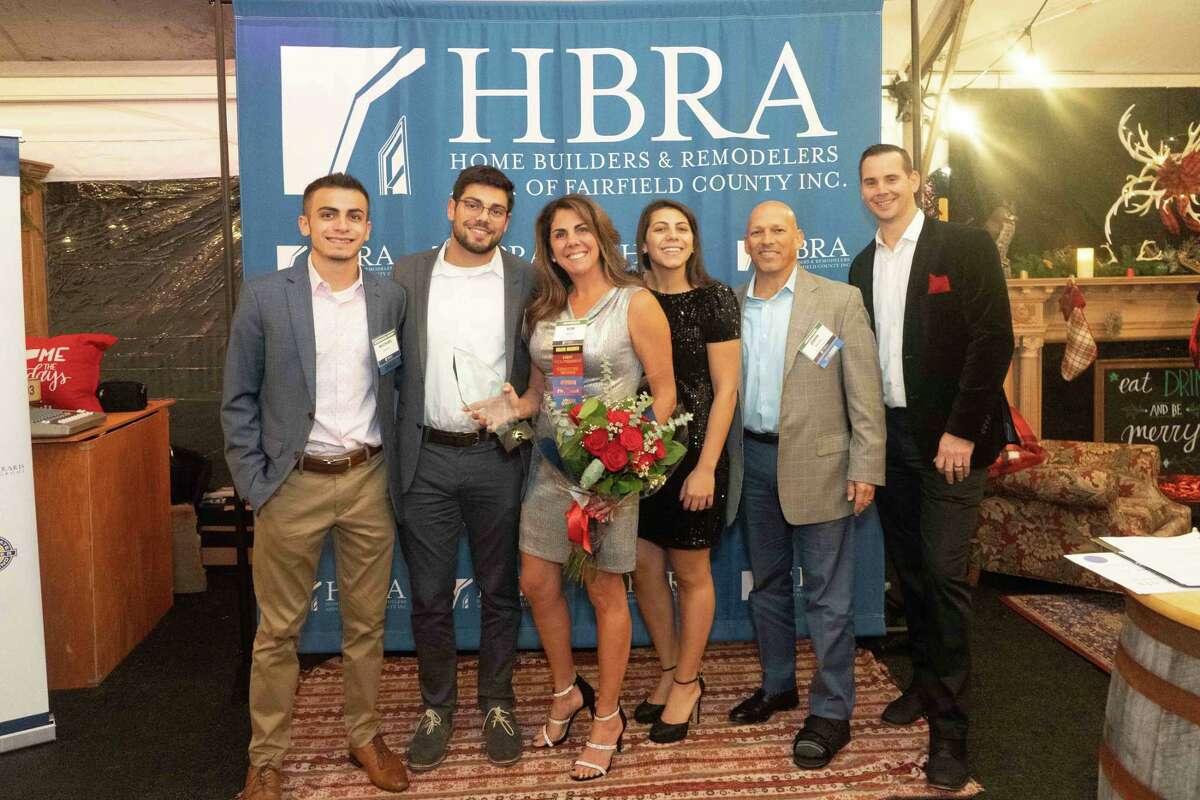 Kim DiMatteo of Bethany, center, branch manager at DiMatteo Insurance of Shelton, recently received the John P. Rowins Meritorious Service Award from the Home Builders and Remodelers Association (HBRA) of Fairfield County and was congratulated by Anthony DeRosa, far right, HBRA President and owner of DeRosa Builders. She is also pictured with her sons, Michael and Anthony DiMatteo, at her left, her daughter, Jessica DiMatteo, at her right, and her husband, John DiMatteo of DiMatteo Financial Services, second from her right, at the Association's Annual Awards Dinner.