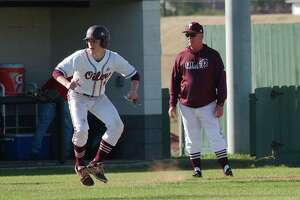 Pearland baseball coach David Rogers (right) hopes Carter Allen (leading off third base) and the rest of the Oilers can feed off their 6-0 start to the season.