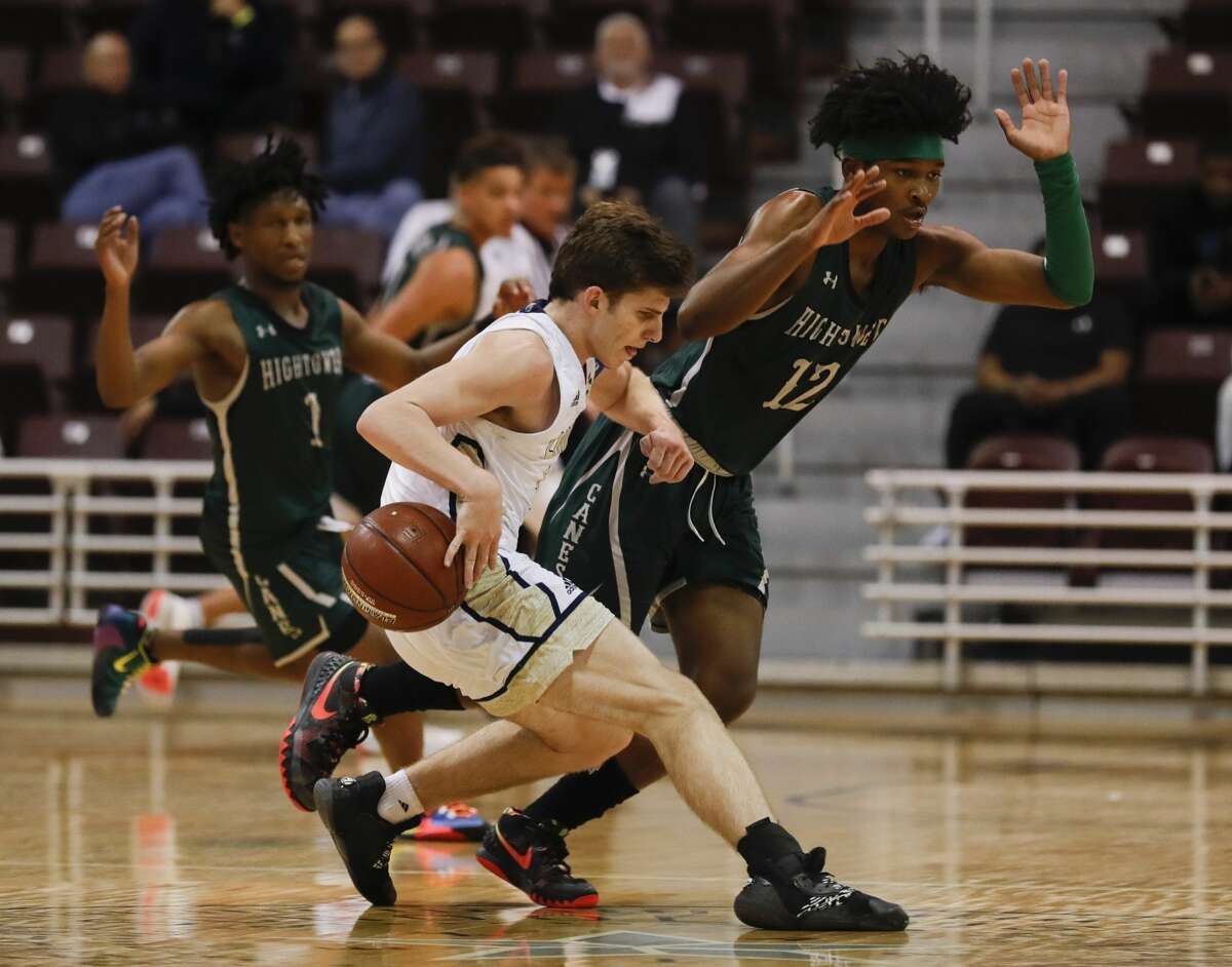 Lake Creek point guard Pierce Spencer (5) dribbles past Fort Bend Hightower point guard Bryce Griggs (12) during the third quarter of a Region III-5A semifinal high school playoff basketball game at the M.O. Campbell Education Center, Friday, March 6, 2020, in Houston.