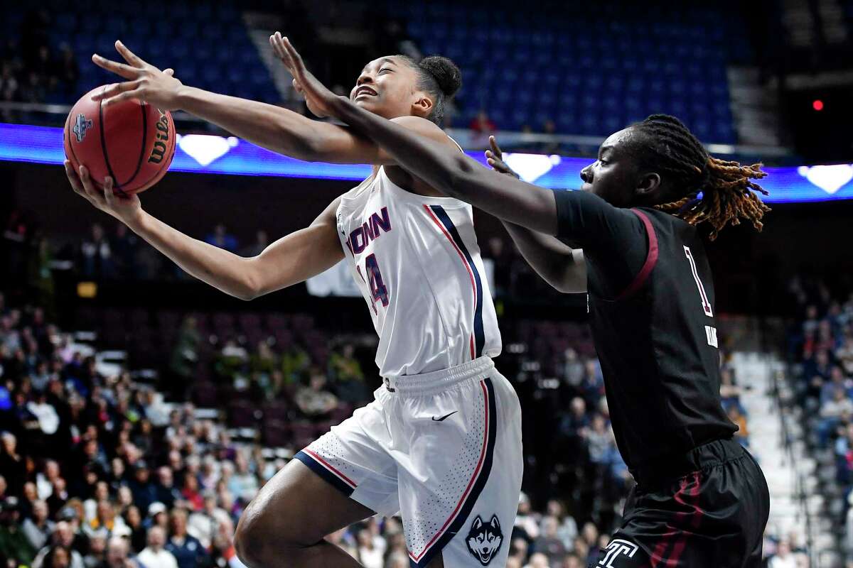 Connecticut’s Aubrey Griffin goes to the basket as Temple’s Lena Niang, right, defends, in the first half of an NCAA women’s basketball game in the American Athletic Conference tournament quarterfinals at Mohegan Sun Arena on Saturday, March 7, 2020 in Uncasville, Conn.