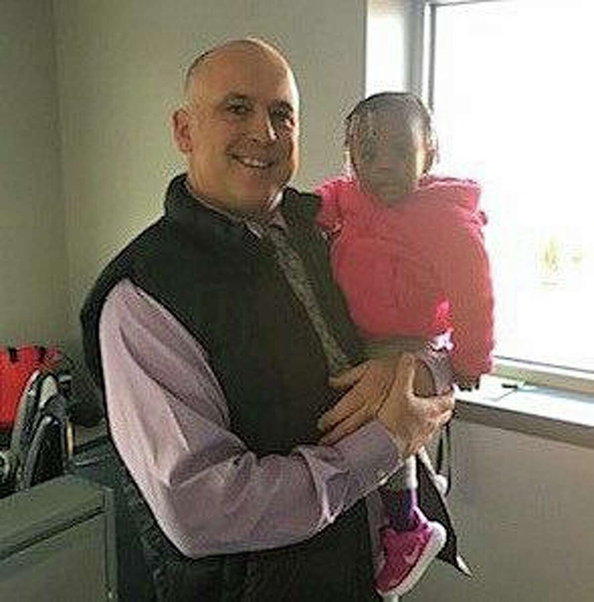 Detective Michael Harton with 1-year-old Eimann, the child he saved last March.