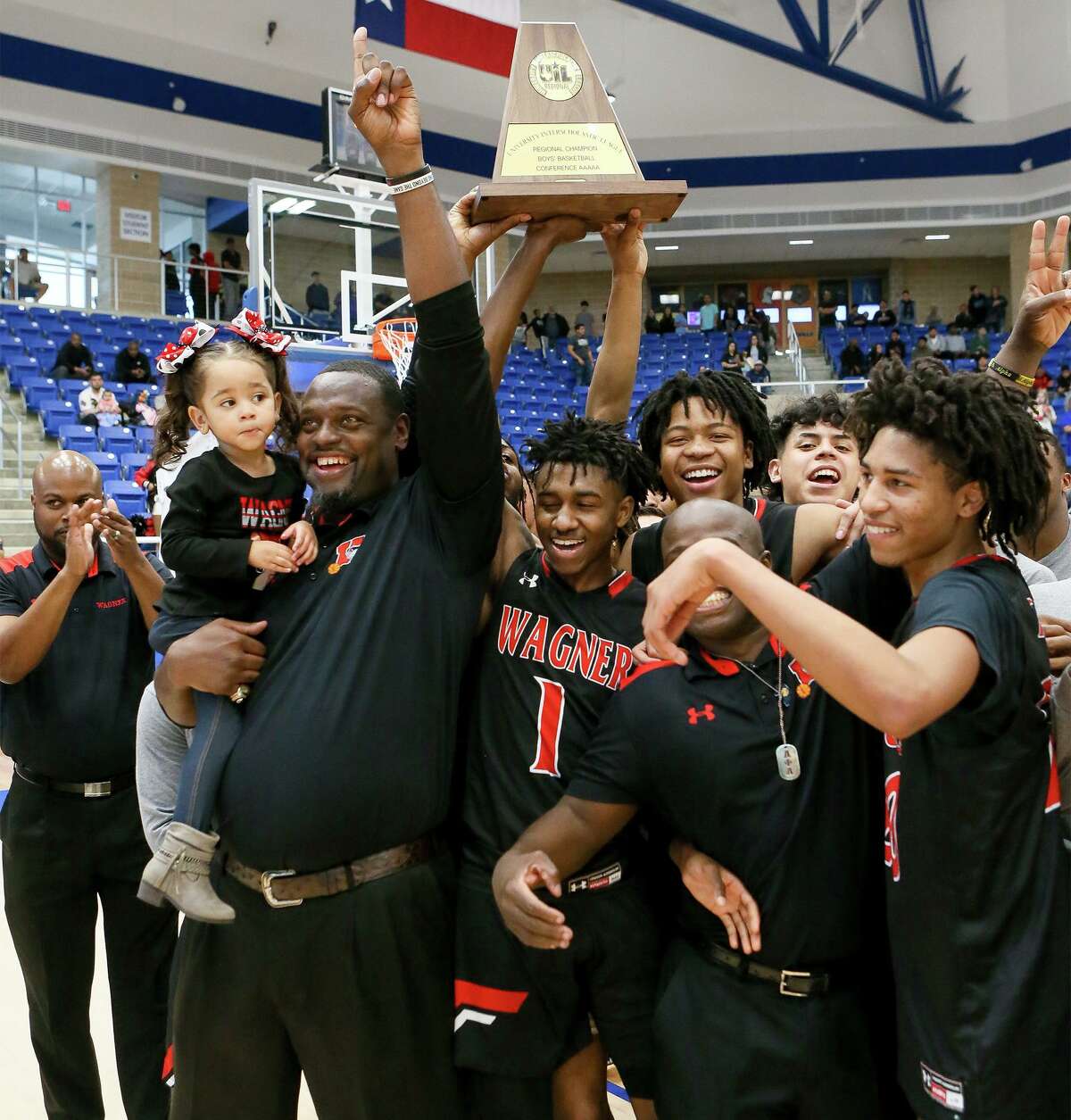 Wagner coach Rodney Clark and the Wagner Thunderbirds celebrate with their 5A regional championship win over Harlan at Northside Gym on March 7, 2020.