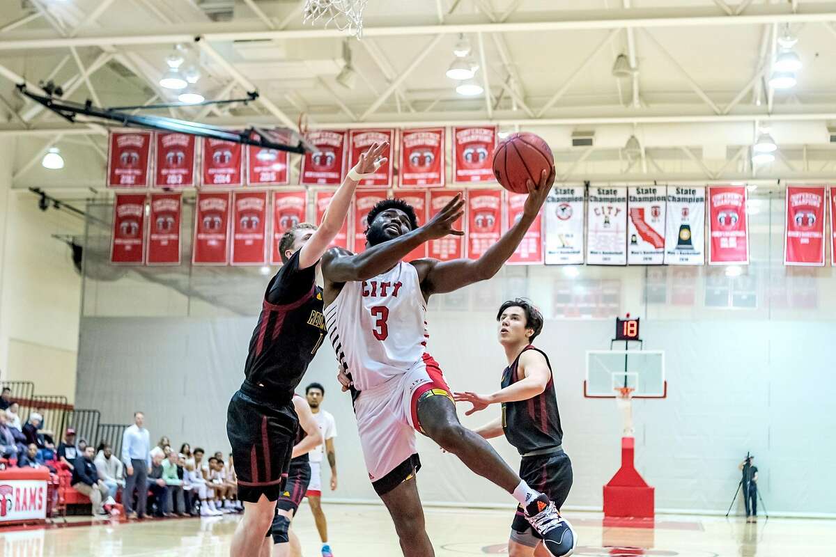 CCSF basketball player�Emeka Udenyi�drives to the basket during a Saturday, March 7, game against Redwoods at CCSF.