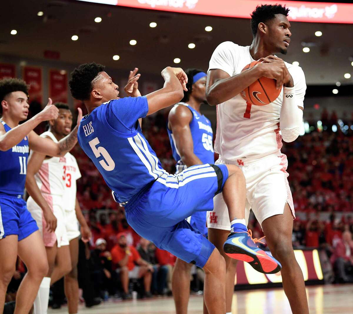 Houston center Chris Harris Jr. (1) rips the ball away from Memphis guard Boogie Ellis (5) during the first half of an NCAA college basketball game, Sunday, March 8, 2020, in Houston.