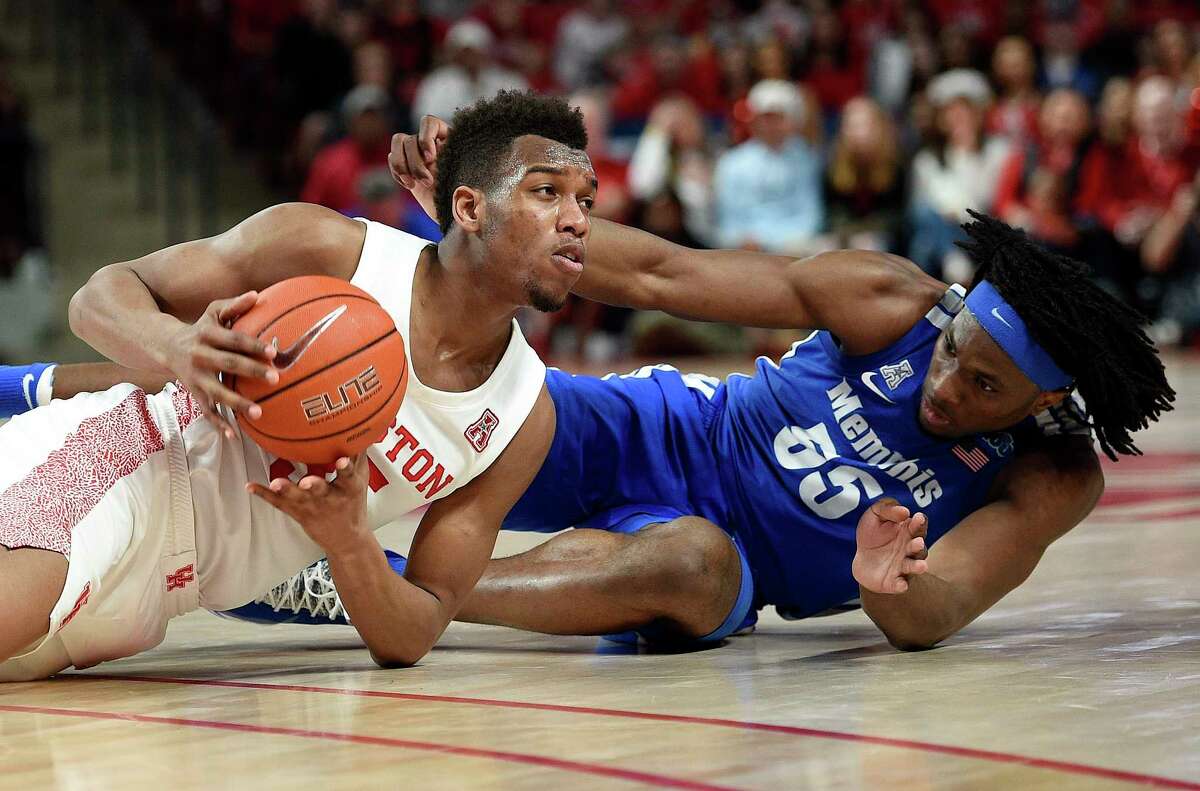 Houston forward Fabian White Jr., left, picks ups. Loose ball from Memphis forward Precious Achiuwa during the second half of an NCAA college basketball game, Sunday, March 8, 2020, in Houston.