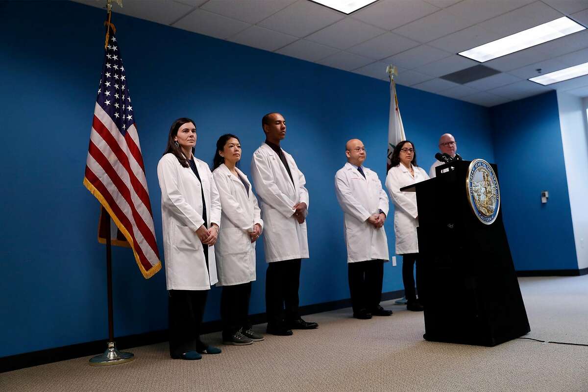 A group of doctors await California Governor Gavin Newsom and Oakland Mayor Libby Schaaf's update, on Grand Princess cruise ship, in Oakland, Calif., on Sunday, March 8, 2020.