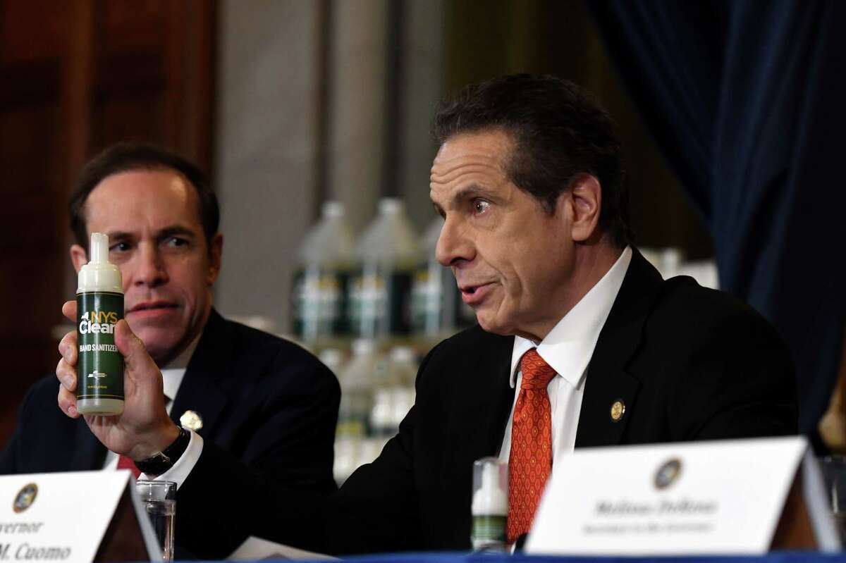 Gov. Andrew Cuomo is joined by State Department of Health Commissioner Dr. Howard Zucker, left, as he announced a new state hand sanitizer to better combat coronavirus during a news briefing on Monday, March 9, 2020, in the Red Room at the Capitol in Albany, N.Y. (Will Waldron/Times Union)