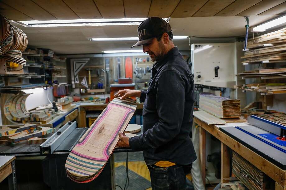 Artist George Rocha shows off a piece of a broken skateboard at his workshop Iris Skateboards on Tuesday, Jan. 21, 2020 in San Francisco, California. He repurposes skateboards to make furniture, skateboards and other objects for his brand Iris Skateboards. Photo: Gabrielle Lurie / The Chronicle