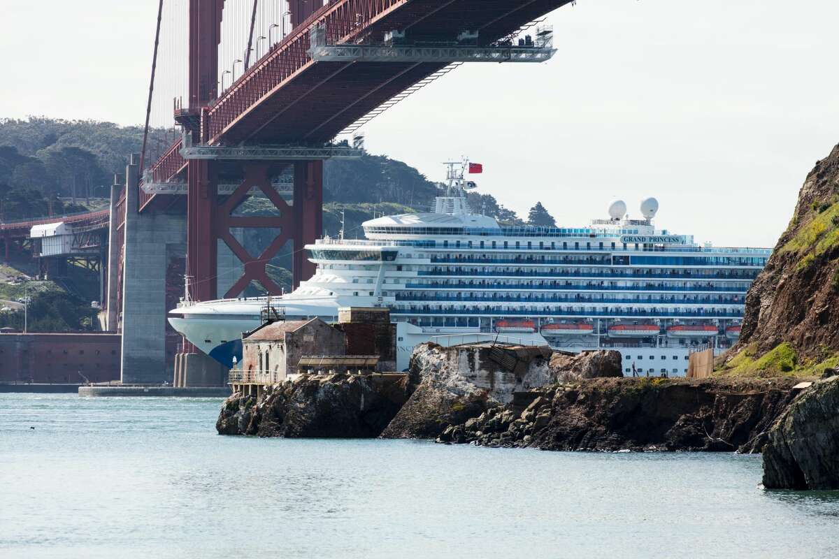 The Grand Princess cruise ship passes under the Golden Gate Bridge as it heads in to dock in Oakland on March 09, 2020. More than 3,000 passengers are stuck at sea after at least 21 people tested positive for the novel coronavirus (COVID-19) on-board.