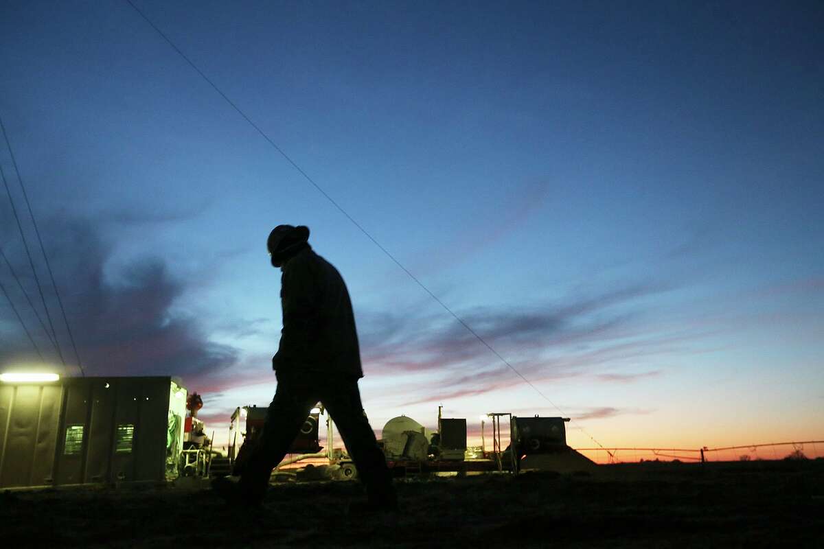 Floorhand Juan Mata, 32, of Alice, Texas walks back to the rig after talking with the toolpusher at the start of the overnight shift at a drilling site in Frio County, Sunday, Jan. 20, 2013.