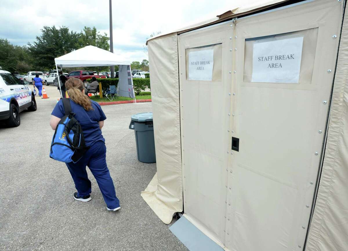 A Veterans' Affairs employee enters a tent being temporarily used as a break room at the Organization's Beaumont office Friday. Several mobile units and military tents are being used to treat patients until the building is renovated from Tropical Depression flooding. Repairs are expected to take months. Photo taken Friday, 9/27/19