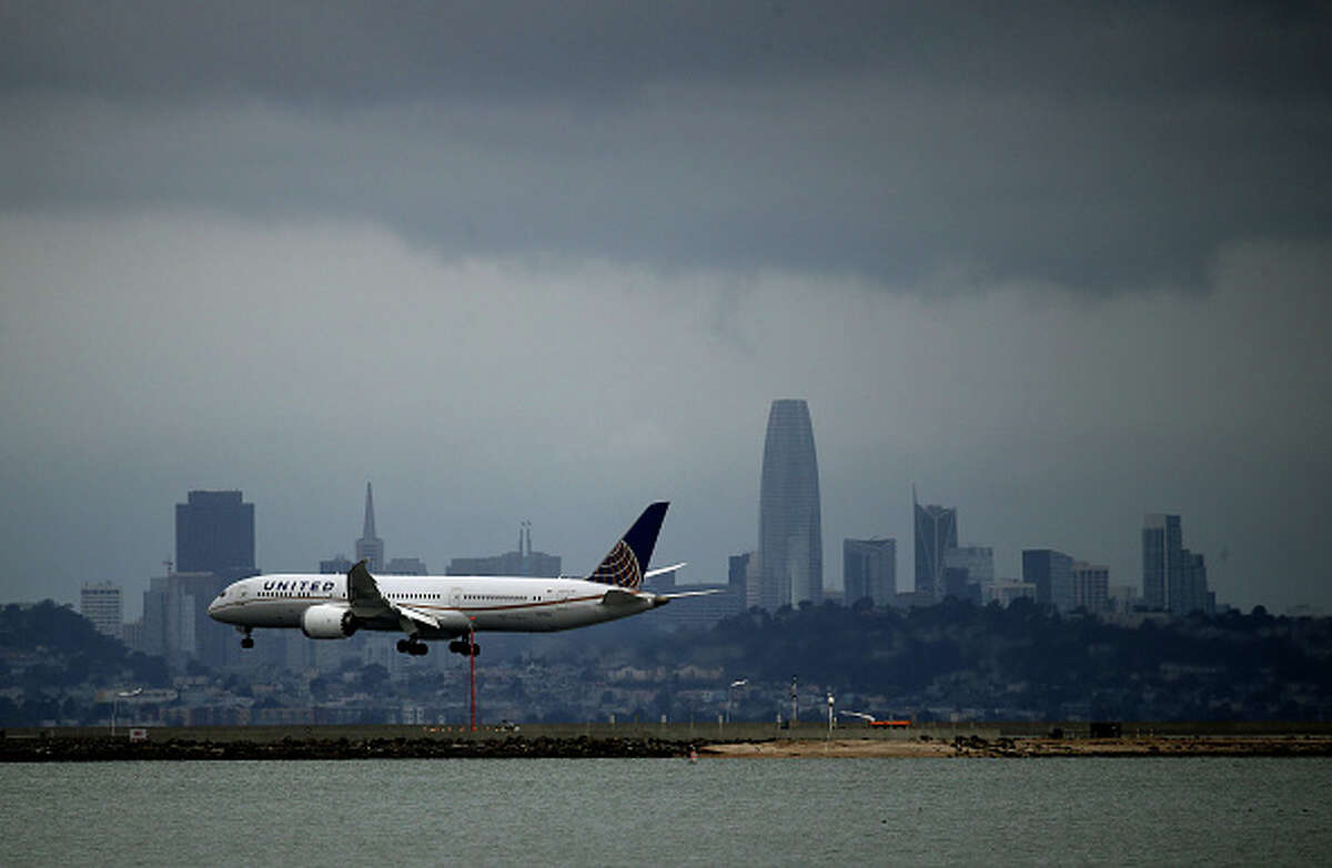 A United Airlines plane lands at San Francisco International Airport. In the wake of the COVID-19 outbreak, airlines are facing significant losses as people are canceling travel plans and businesses are restricting travel.