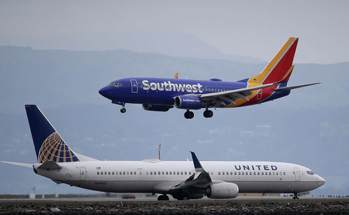 Airlines are relaxing change fee policies to reassure anxious travelers in the era of coronavirus. Pictured: A Southwest Airlines plane lands next to a United Airlines plane at San Francisco International Airport on March 06, 2020 in Burlingame, California. In the wake of the COVID-19 outbreak, airlines are facing significant losses as people are cancelling travel plans and businesses are restricting travel. Southwest Airlines says they expect to lose between $200 to $300 million dollars in the coming weeks. Other airlines like United and Jet Blue are cutting flights. The International Air Transport Association predicts that carriers could lose between $63 billion and $113 billion this year.