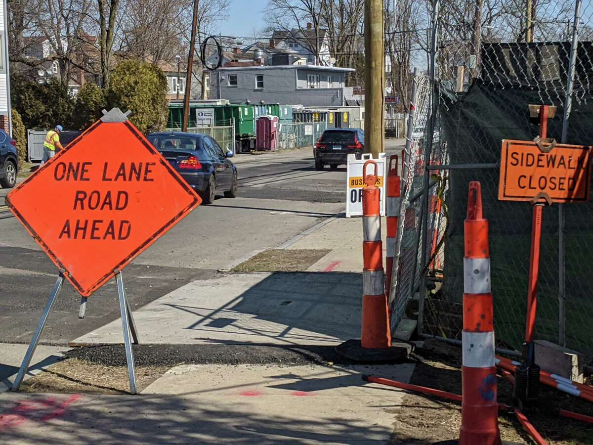 Signs are posted to warn drivers of one-lane alternating traffic during the road work.