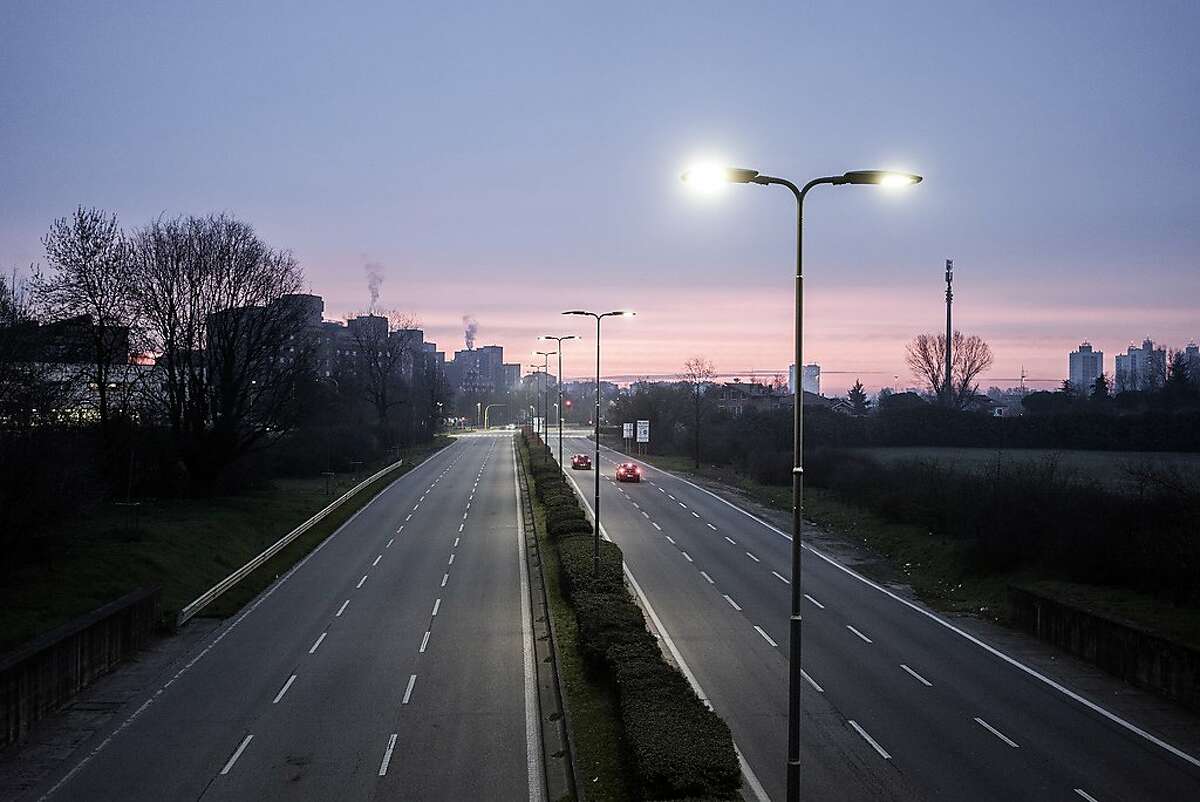 An access road to Milan, usually busy with workers, is nearly deserted, March 10, 2020. All of Italy's 60 million people are coming under restrictions that had earlier applied to the northern part of the country. (Alessandro Grassani/The New York Times)