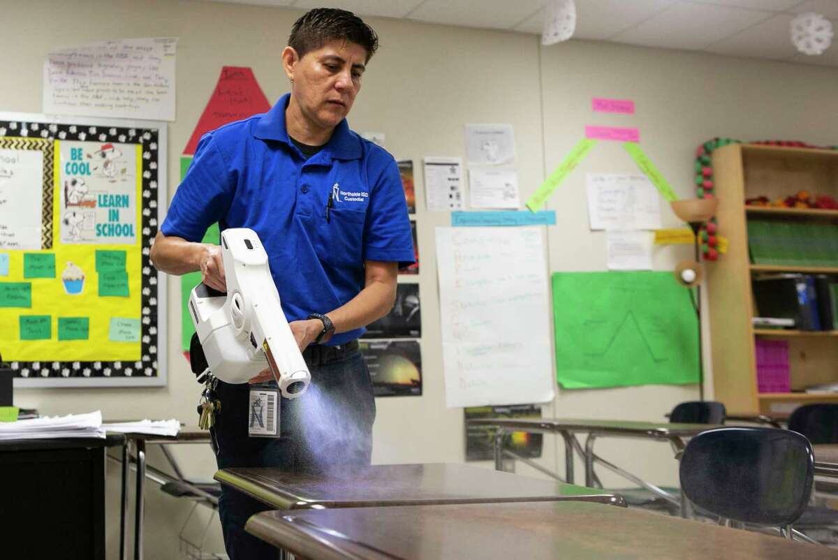 Head Campus Custodian Patricia Avila uses an electrostatic sprayer to clean classrooms of Dolph Briscoe Middle School in San Antonio, Texas, March 9, 2020. Northside ISD Superintendent Brian Woods sent a letter to parents about coronavirus and Spring Break informing parents that while the students are gone, extra cleaning will be done in classrooms.