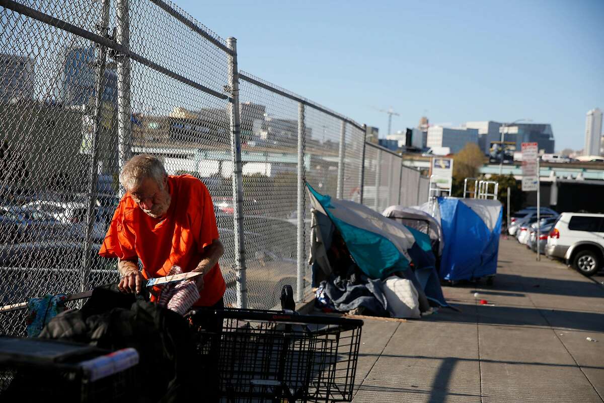 Bill Smith makes preparations at the site where he is planning to sleep for the night on Wednesday, March 4, 2020 in San Francisco, Calif. Smith says he has been dealing with homelessness on and off for approximately 20 years.