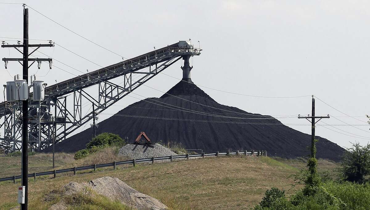 File - This July 29, 2013, file photo shows a Luminant Mining Co. coal mine working in Tatum, Texas.