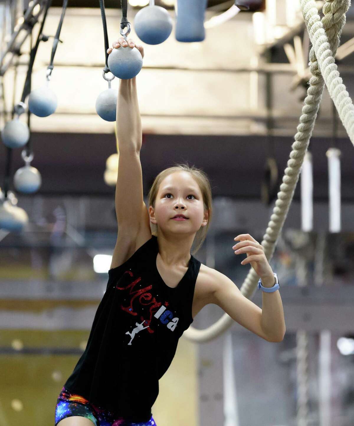 10 year old Meredith Kim works on the Cannon Balls during practice on Friday, March 6, 2020 at Iron Sports in Houston Texas.