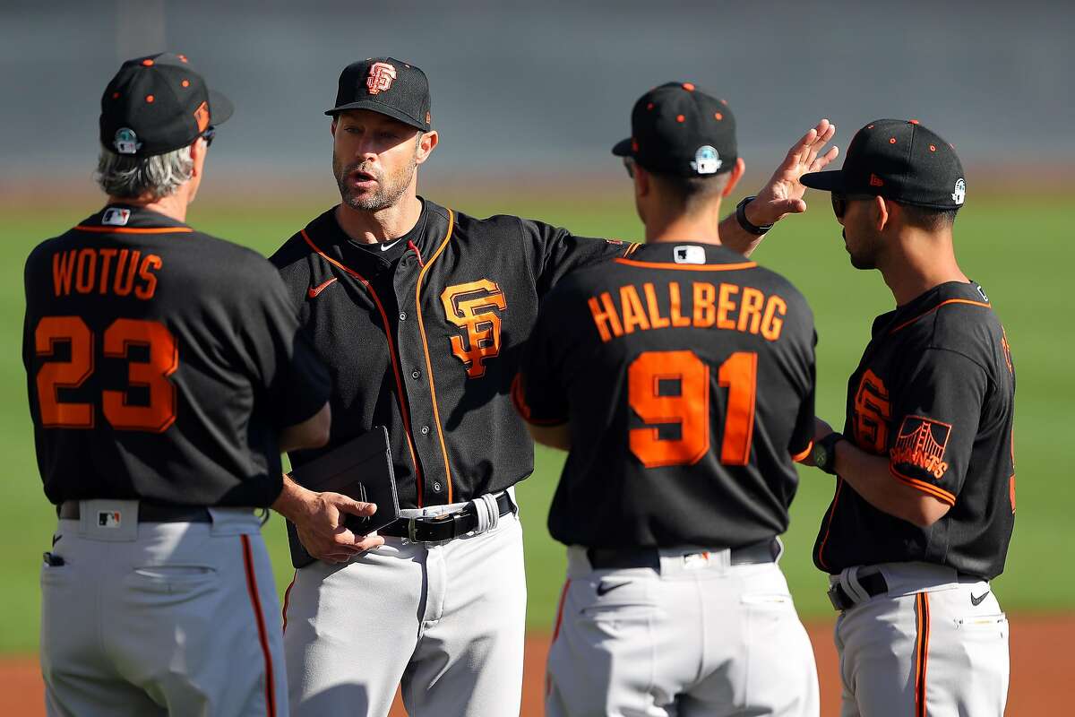 SCOTTSDALE, AZ - FEBRUARY 18: Manager Gabe Kapler #19 speaks with third base coach Ron Wotus #23, assistant coach Mark Hallberg #91, and infield coach Kai Correa #50 of the San Francisco Giants during a workout on Tuesday, February 18, 2020 at Scottsdale Stadium in Scottsdale, Arizona. (Photo by Alex Trautwig/MLB Photos via Getty Images)