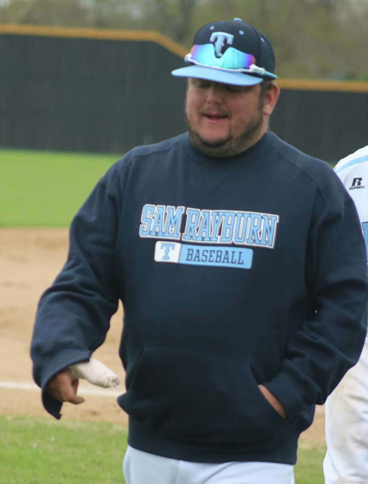 New Sam Rayburn baseball coach Jaime Acosta leaves the third-base box over the weekend, sporting his heavily-bandaged right thumb. He'll be using the rest of spring break to begin the healing process from Wednesday's surgery.