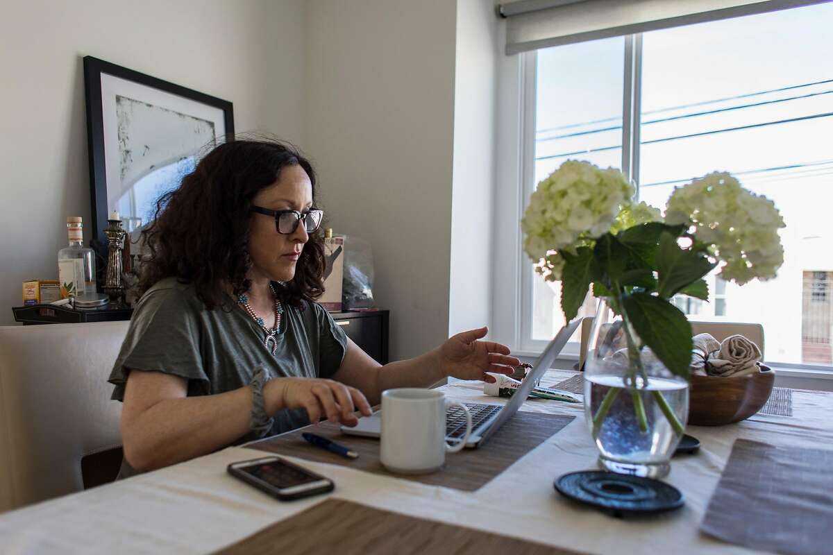 Diana Zaslaw works from her home in the Outer Richmond District in San Francisco, Calif. on Tuesday, March 10 amid fears of the Coronavirus.