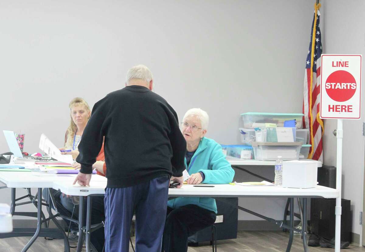 Election inspectors check a voter in at the Chippewa Hills Community Center. According to Clerk Kristin Lytle, voter turnout was higher than usual. (Pioneer photo/Catherine Sweeney)