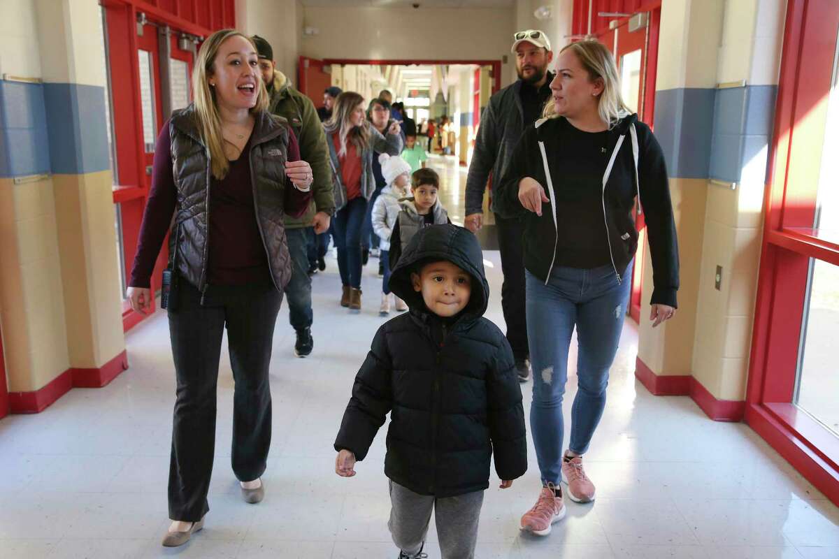 Five-year-old Jake Villanueva leads a group of Pre-K 4 SA students and parents as they arrive at Hatchett Elementary School for a tour, Wednesday, Feb. 26, 2020. The “Welcome to Kinder” event aims to reach out to the parents and students who will decide where their child will go to kindergarten. Behind Jake, his mother, Audrey Solis, right, talks with the school’s Vice Principal Nicole Freemyer.
