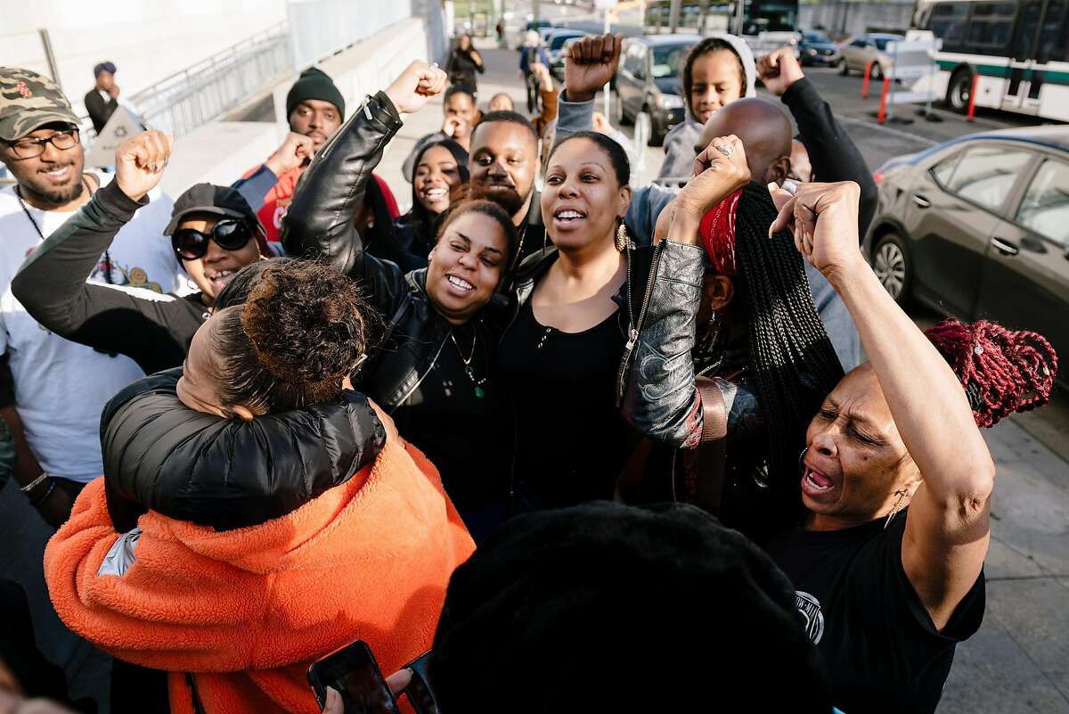 Family and friends of Nia Wilson cheer outside the Alameda County Superior Courthouse following a guilty verdict was handed down to defendant John Cowell, who was accused of her fatal 2018 BART station stabbing, in Oakland, California, on Tuesday, March 10, 2020.