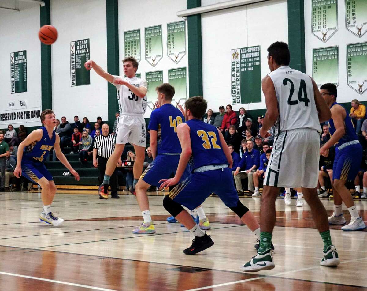 Pine River senior guard Lane Ruppert makes a mid-air pass from the top of the key during the Bucks' 59-48 win over Mason County Central on Monday night. (Herald Review photo/Joe Judd)
