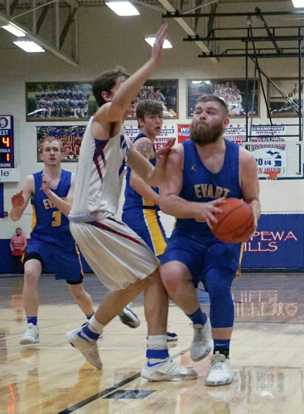 Evart senior Justin Buckner looks to score during the Wildcats' 70-39 win against the Chippewa Hills Warriors on Thursday evening in Remus. (Herald Review photo/Joe Judd)