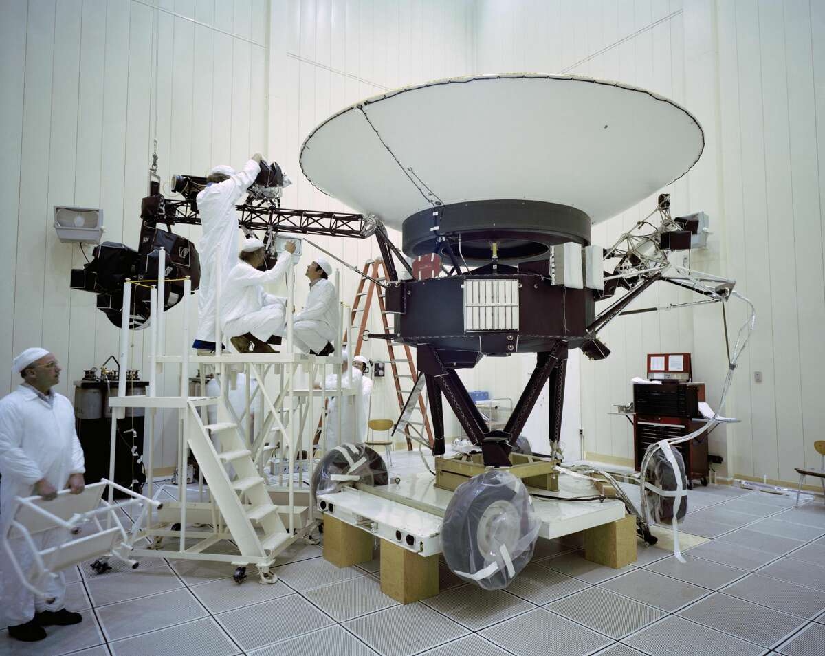 This photo shows engineers working on NASA's Voyager 2 spacecraft on March 23, 1977.