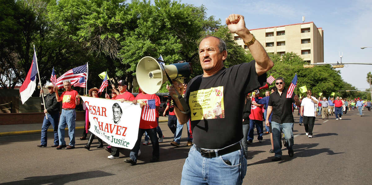 President for the Labor Council for Latin American Advancement (LCLAA) Webb County Chapter, Manuel Bocanegra, leads a crowd Saturday morning, as they march down Matamoros St in downtown Laredo during the 11th Annual Chesar Chavez's March for Justice.