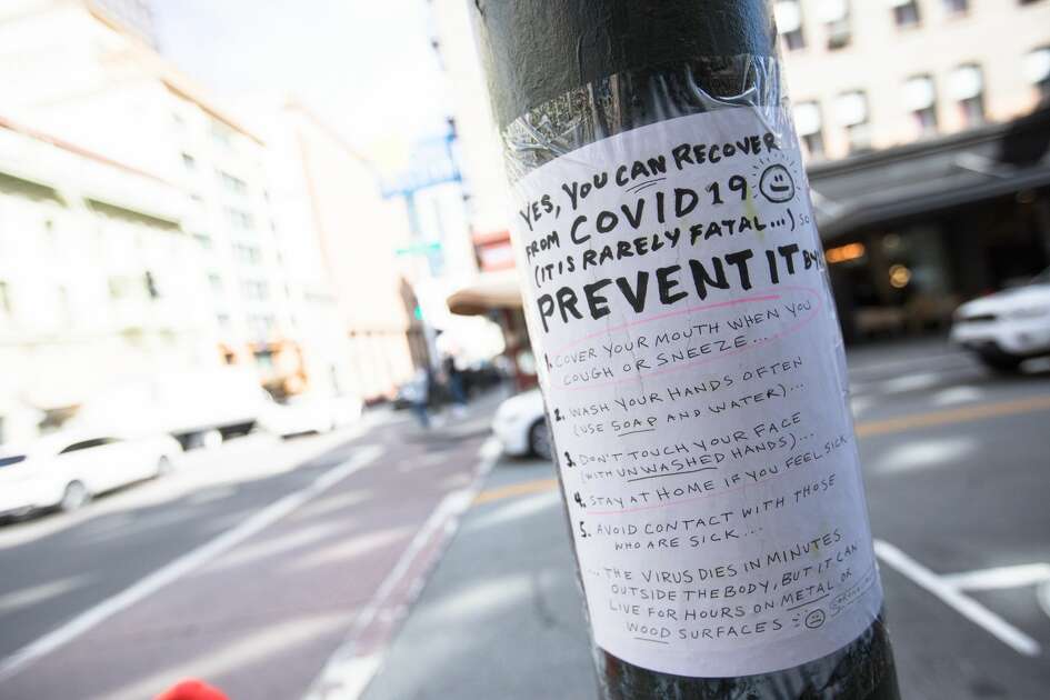 A handmade sign on Grant Ave. in San Francisco, Calif. on March 10, 2020 explains how to contain the COVID-19 coronavirus. The streets of San Francisco were noticeably more quiet because of the coronavirus, which has prompted many employees to encourage workers to stay at home.