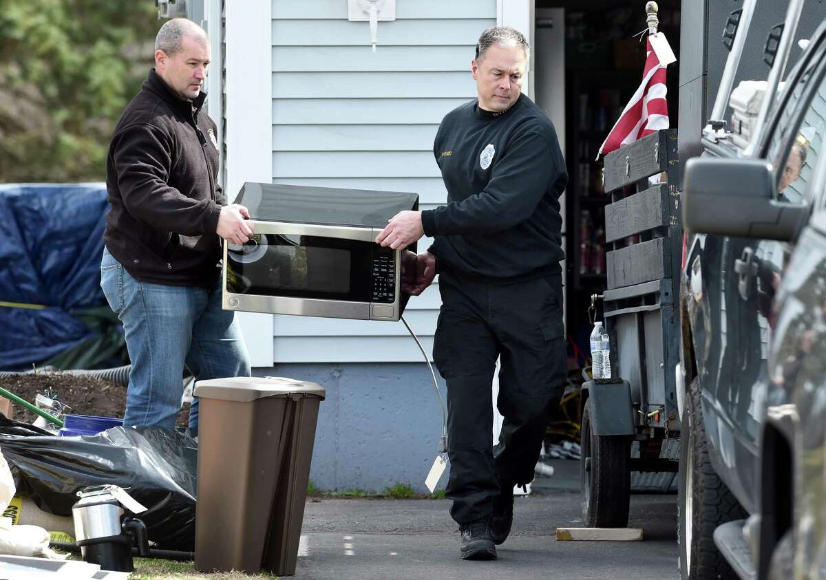 West Haven Police remove items from the home of former West Haven High School Athletic Director Jon Capone at 326 Benham Hill Road in West Haven on March 11, 2020.