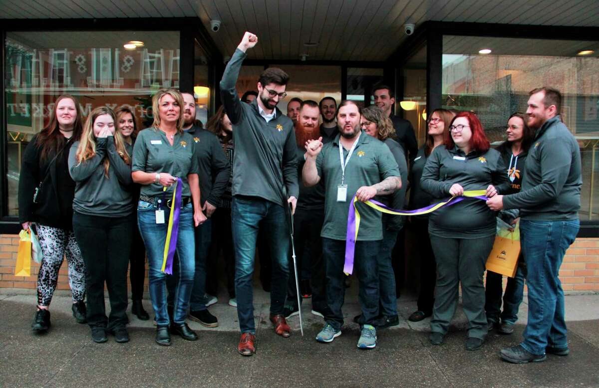 Lume employees, as well as a few customers, were all smiles Wednesday morning as Lume Cannabis Co. inventory analyst Tyler Johnson cut a ribbon in celebration of opening day. (Pioneer photo/Alicia Jaimes)
