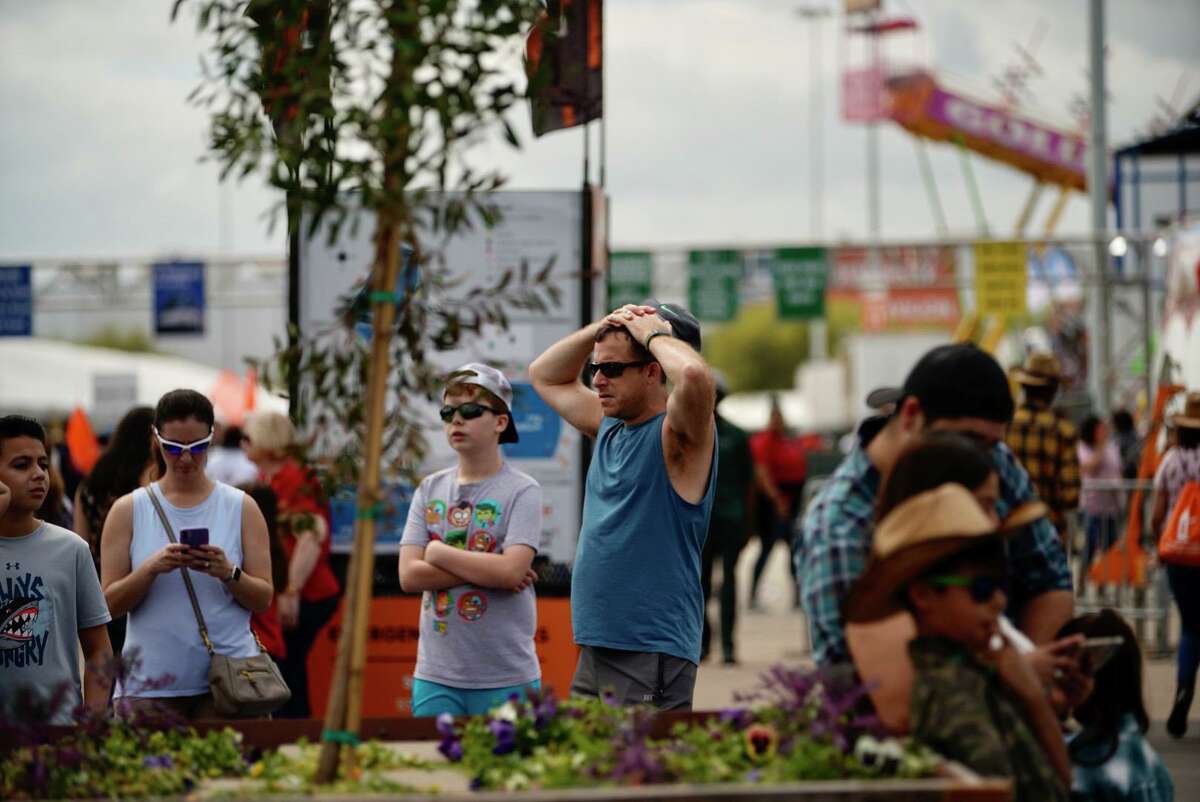 Visitors to the Houston Livestock Show and Rodeo react as people begin to find out that the rodeo is being closed, Wednesday, March 11, 2020, at NRG Center in Houston.