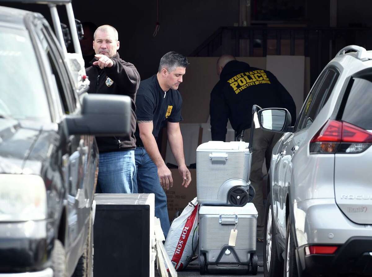 West Haven police remove items from the home of former West Haven High School Athletic Director Jonathan P. Capone at 326 Benham Hill Road in West Haven March 11, 2020.