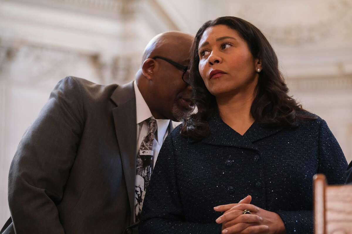 Dr. Vincent Mathews, Superintendent of the San Francisco Unified School District speaks to Mayor London Breed, during a press conference announcing that San Francisco schools will remain open in San Francisco, Calif. on Wednesday, March 11, 2020.