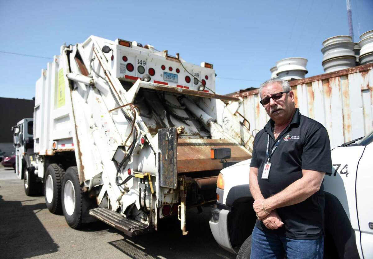 Fleet Manager Michael Scacco shows one of the garbage trucks that will be used for leaf collection at the Stamford Fleet Maintenance center in Stamford, Conn. Tuesday, Aug. 21, 2018. As a cost-saving measure, Stamford will deploy three garbage trucks to collect bagged leaves instead of the using the large leaf "vacuums" as in the past. The trucks were used as backups before and are getting standard maintenance done to get their capacities on par with the rest of the fleet.