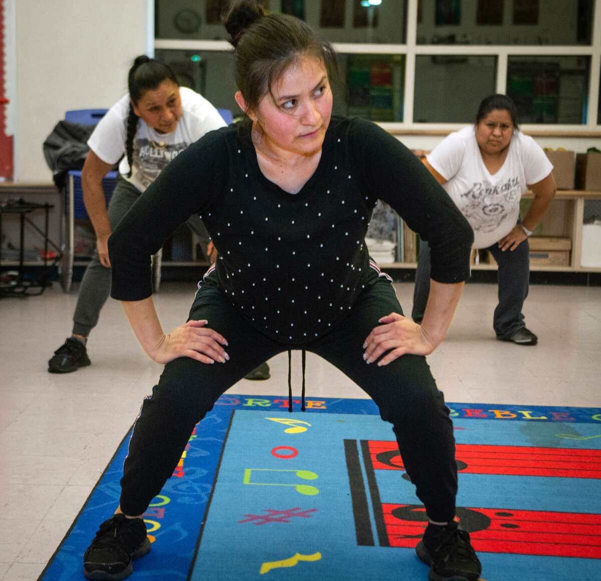 Eunice Castelan Castelan keeps her eye on the instructor a during an exercise and nutrition class at John S. Martinez School in New Haven. In the back are Georgina Castelan, left, and Juana Rodriguez.